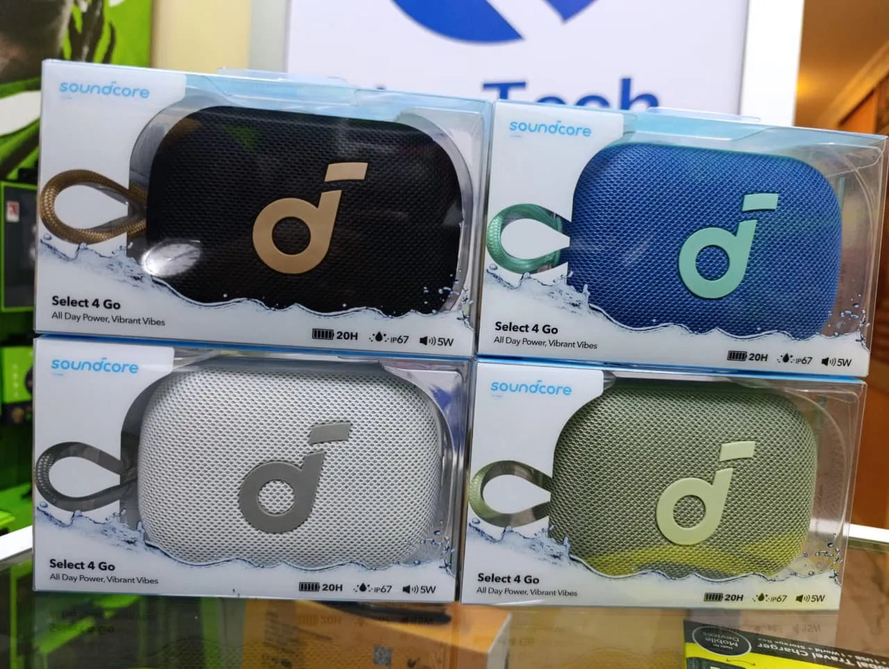 Four packages of Soundcore Select 4 Go portable speakers in different colors.
